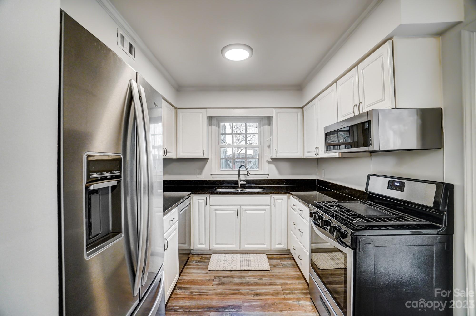 3500 Colony Road, Unit E Charlotte, NC 28211 - Photo 8 of 37 a kitchen with stainless steel appliances a sink stove and refrigerator