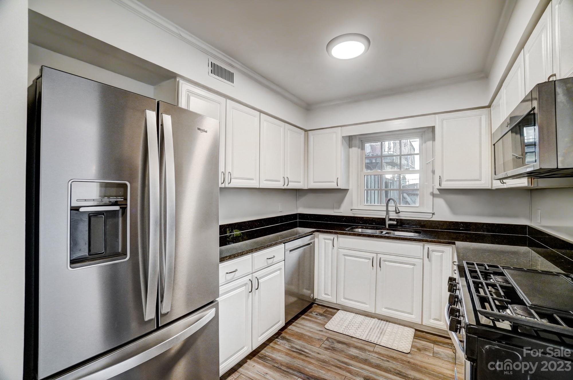 3500 Colony Road, Unit E Charlotte, NC 28211 - Photo 9 of 37 a kitchen with granite countertop a refrigerator and a sink