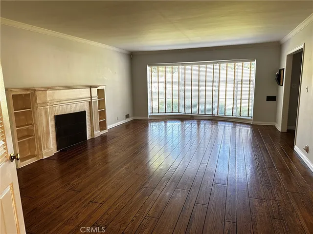 wooden floor fireplace and natural light in room