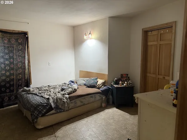 a bedroom with a bed and a mirror