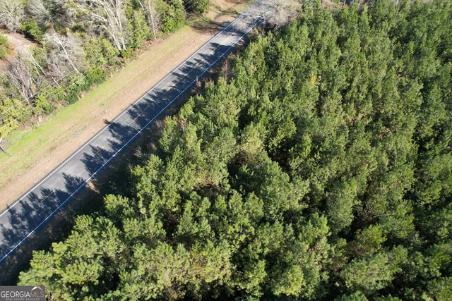 view of a field with trees in background