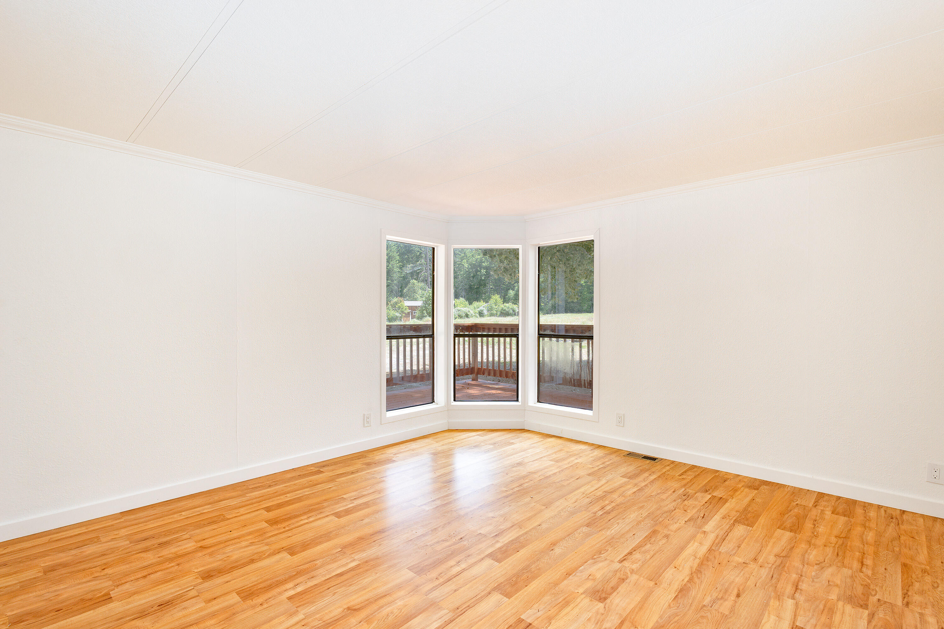 601 Pinewood Way Cave Junction, OR 97523 - Photo 19 of 33 a view of an empty room with wooden floor and a window