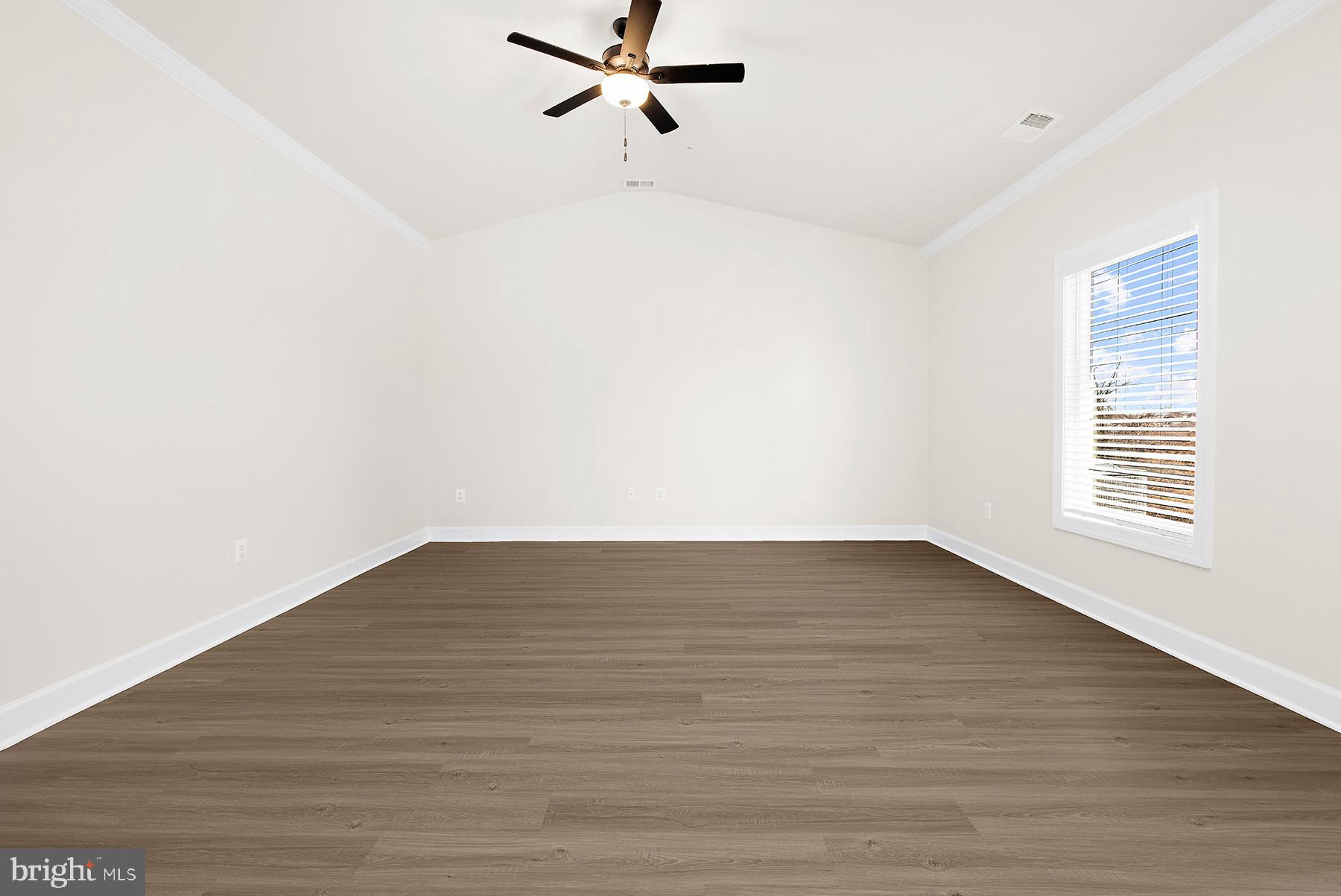 5211 McCormick Avenue Baltimore, MD 21206 - Photo 4 of 20 a view of an empty room with wooden floor and a window