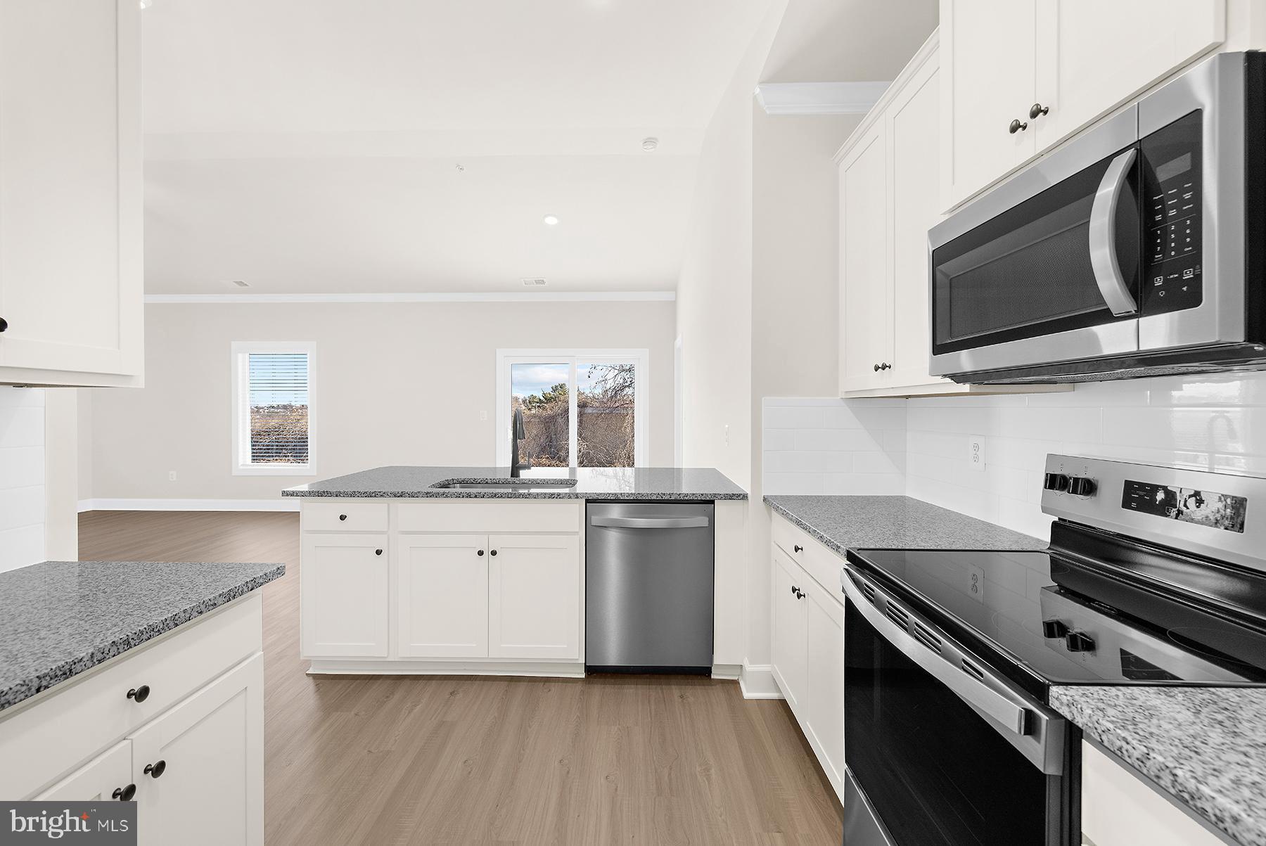 5211 McCormick Avenue Baltimore, MD 21206 - Photo 9 of 20 a kitchen with a sink stove and microwave