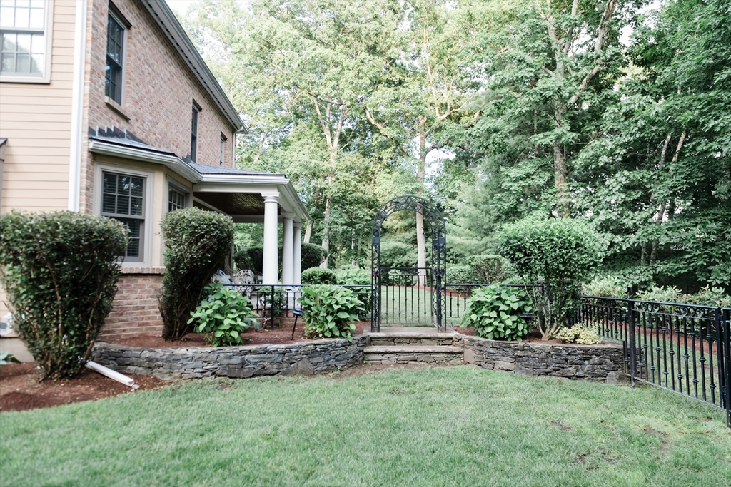 56 Sears Road Southborough, MA 01772 - Photo 20 of 26 a view of a house with a yard and plants