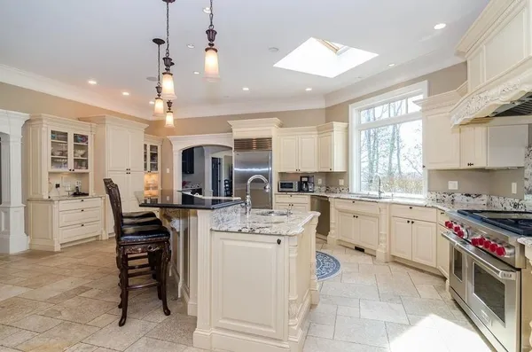 a kitchen with cabinets and chairs