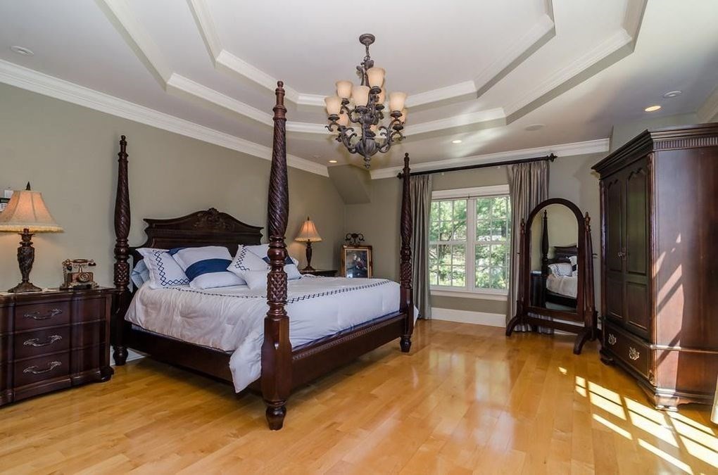 56 Sears Road Southborough, MA 01772 - Photo 10 of 26 a bedroom with a bed and a chandelier