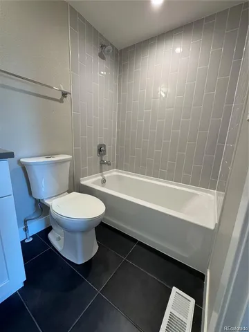 a bathroom with a toilet a sink and bathtub