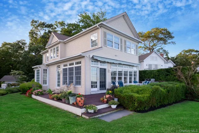 a front view of a house with a yard and plants