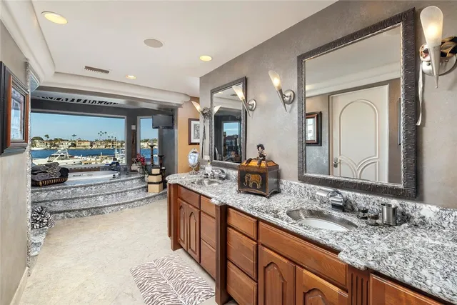 a bathroom with a sink double vanity and a mirror