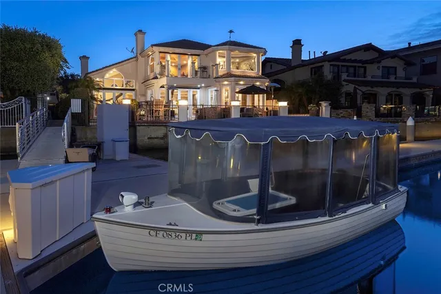 an aerial view of a city with lots of residential buildings ocean and mountain view in back