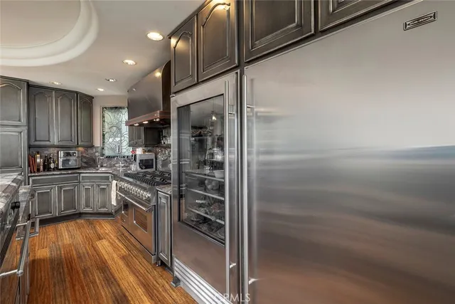 a kitchen with granite countertop stainless steel appliances and counter space