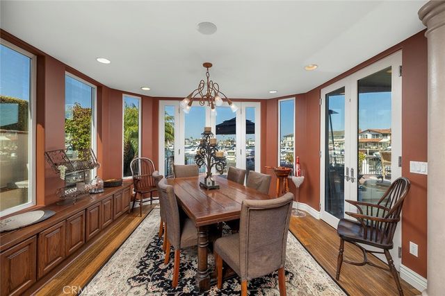 a dining room with furniture a chandelier and wooden floor