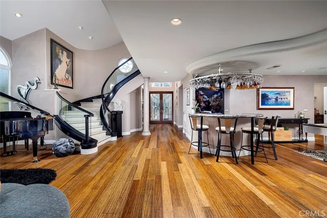 a view of livingroom with furniture entryway and wooden floor
