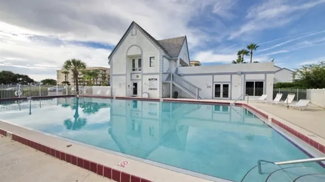 a view of a white house next to a yard