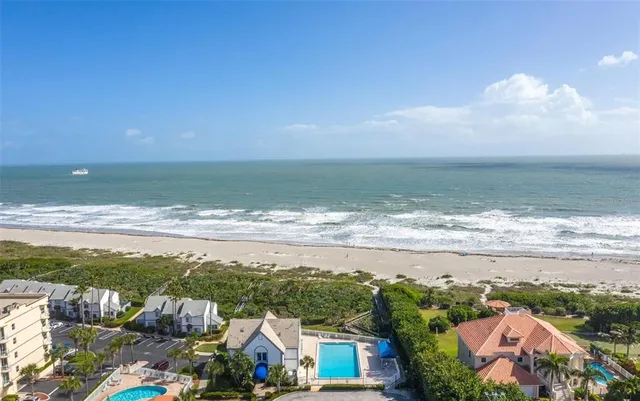 an aerial view of a house with a ocean view
