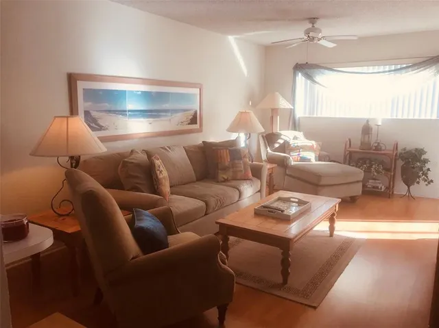 a living room with furniture and a lamp