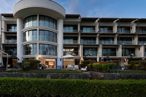 a front view of a residential apartment building with a yard