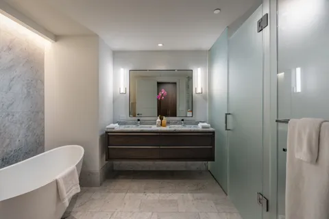 a view of bathroom with bathtub shower and mirror