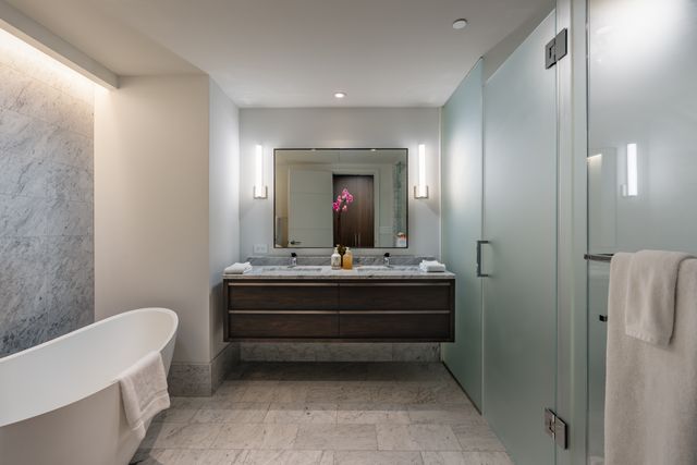 a view of bathroom with bathtub shower and mirror