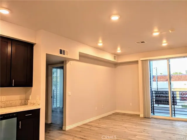 a kitchen with stainless steel appliances kitchen island granite countertop a refrigerator and a stove top oven