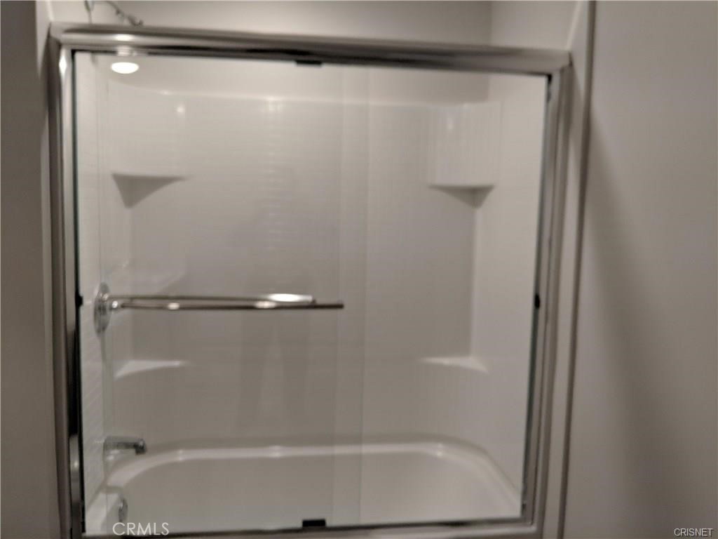 7343 Reseda Boulevard, Unit 303 Reseda, CA 91335 - Photo 6 of 10 a bathroom with a glass shower door