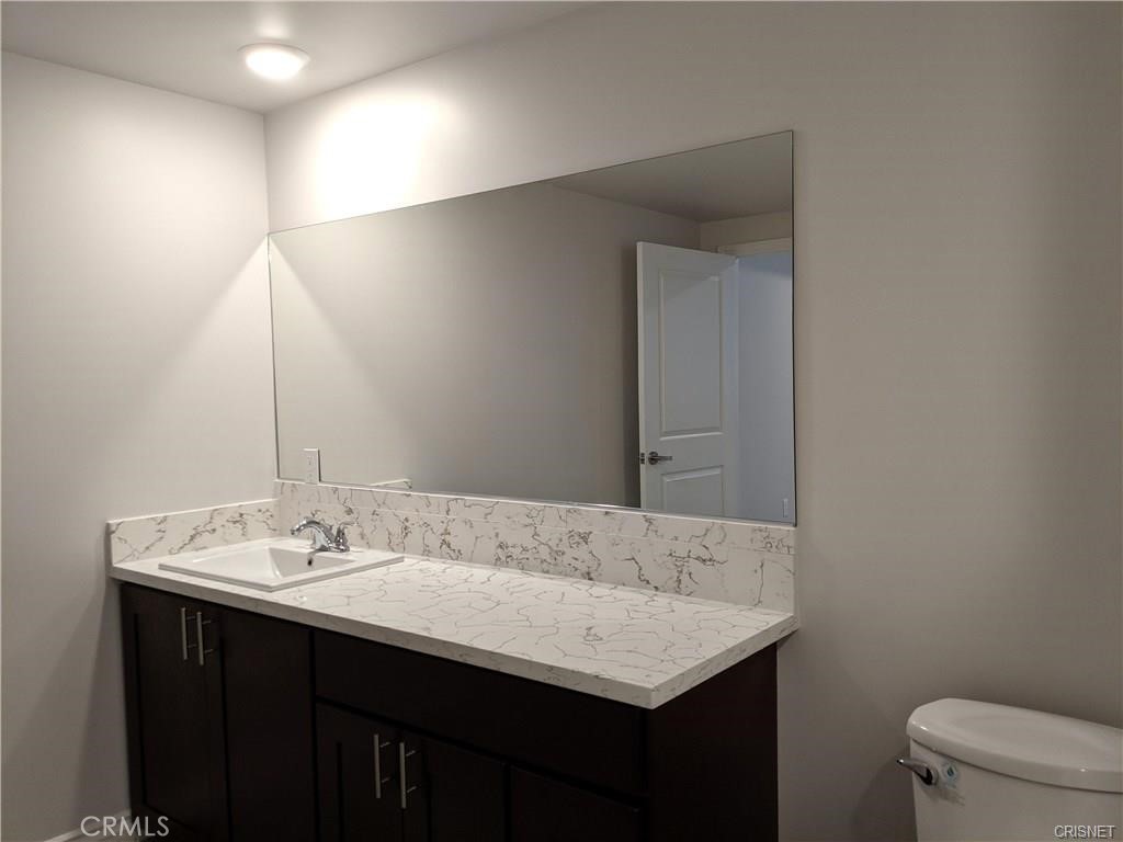 7343 Reseda Boulevard, Unit 303 Reseda, CA 91335 - Photo 7 of 10 a bathroom with a sink and a toilet