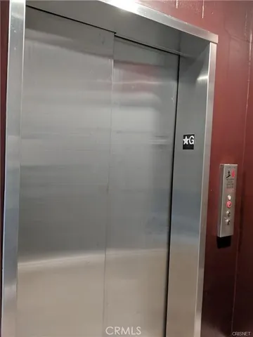 a view of walk in closet and empty room