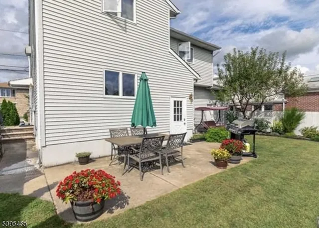 a view of a backyard with furniture and a potted plants