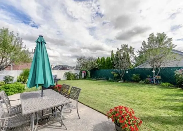 a view of a backyard with a garden and entertaining space