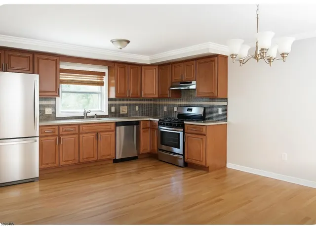 a kitchen with a sink a stove a refrigerator and a microwave