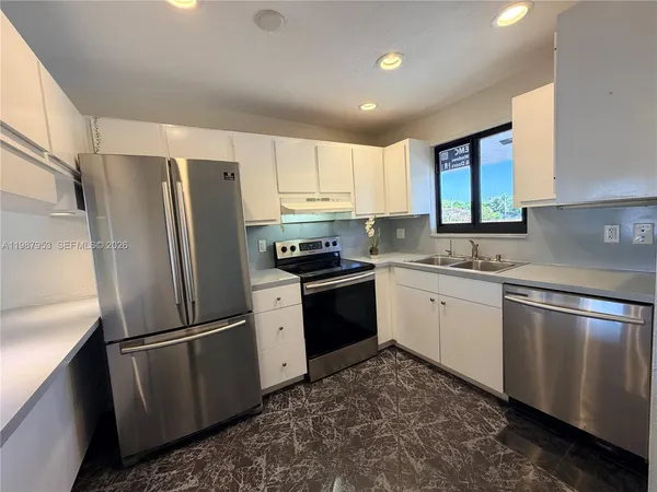 a kitchen with a refrigerator stove and sink