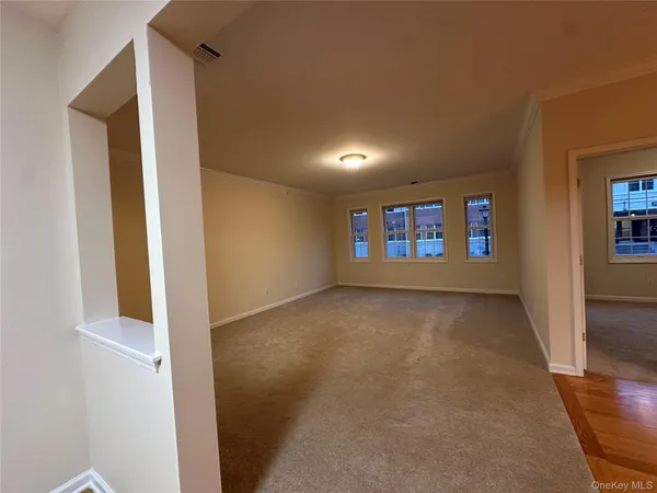 a view of a room with wooden floor and chandelier