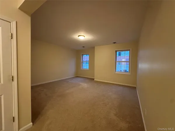 a large bathroom with a granite countertop sink a toilet a mirror and vanity