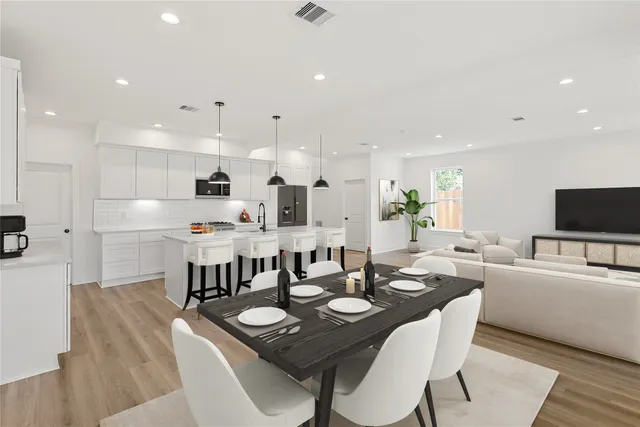 a view of a dining room with furniture and wooden floor