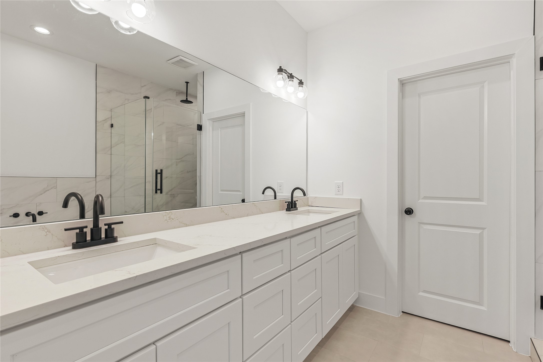 7413 Charlie Street Houston, TX 77088 - Photo 17 of 26 a bathroom with double sink and a mirror