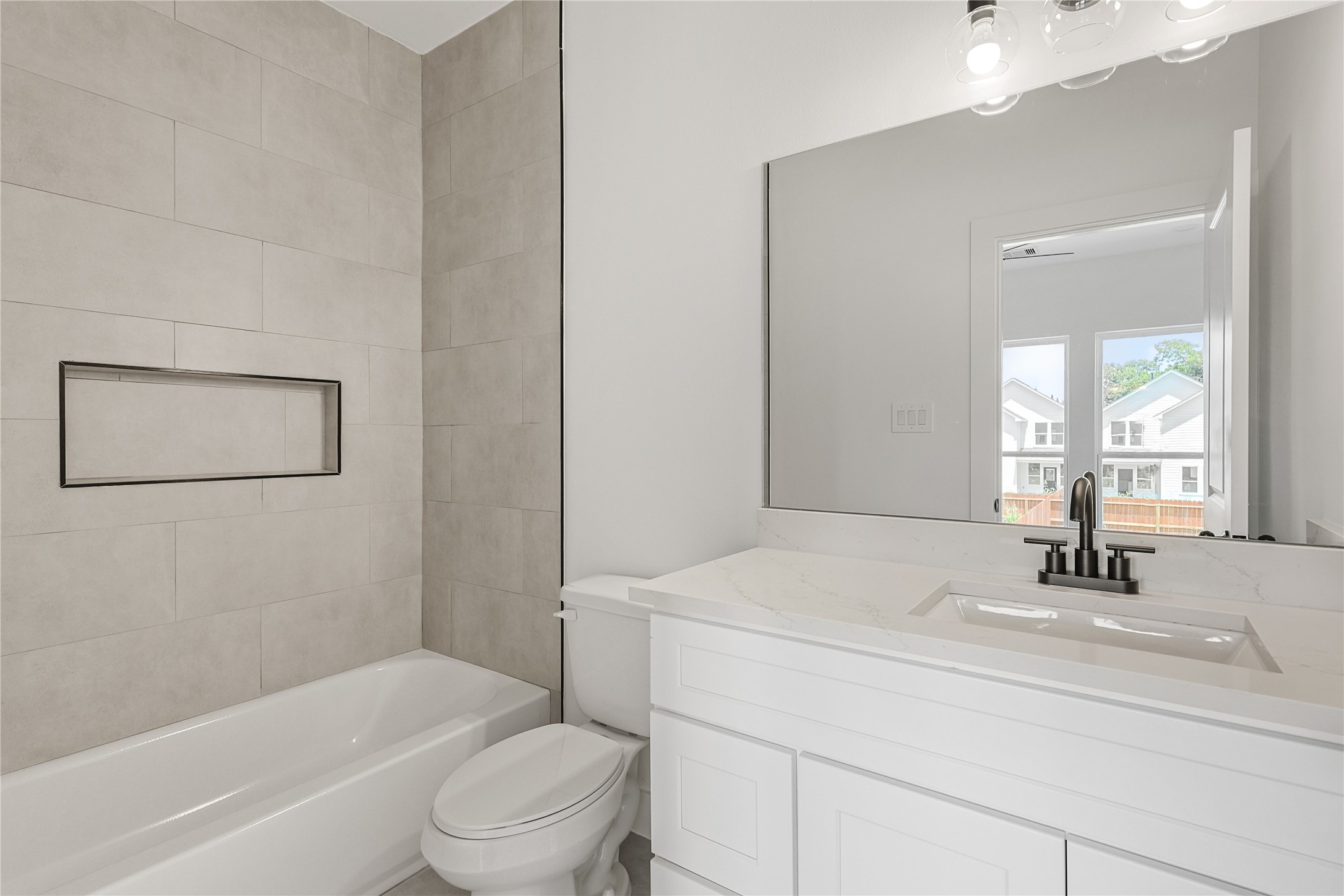 7413 Charlie Street Houston, TX 77088 - Photo 23 of 26 a bathroom with a sink a toilet and shower