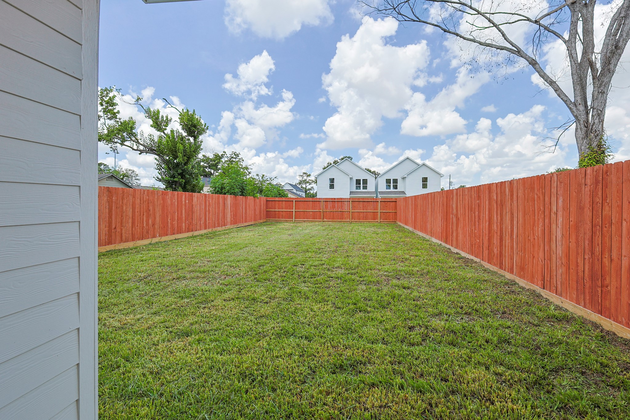 7413 Charlie Street Houston, TX 77088 - Photo 24 of 26 a view of yard with swimming pool and wooden fence