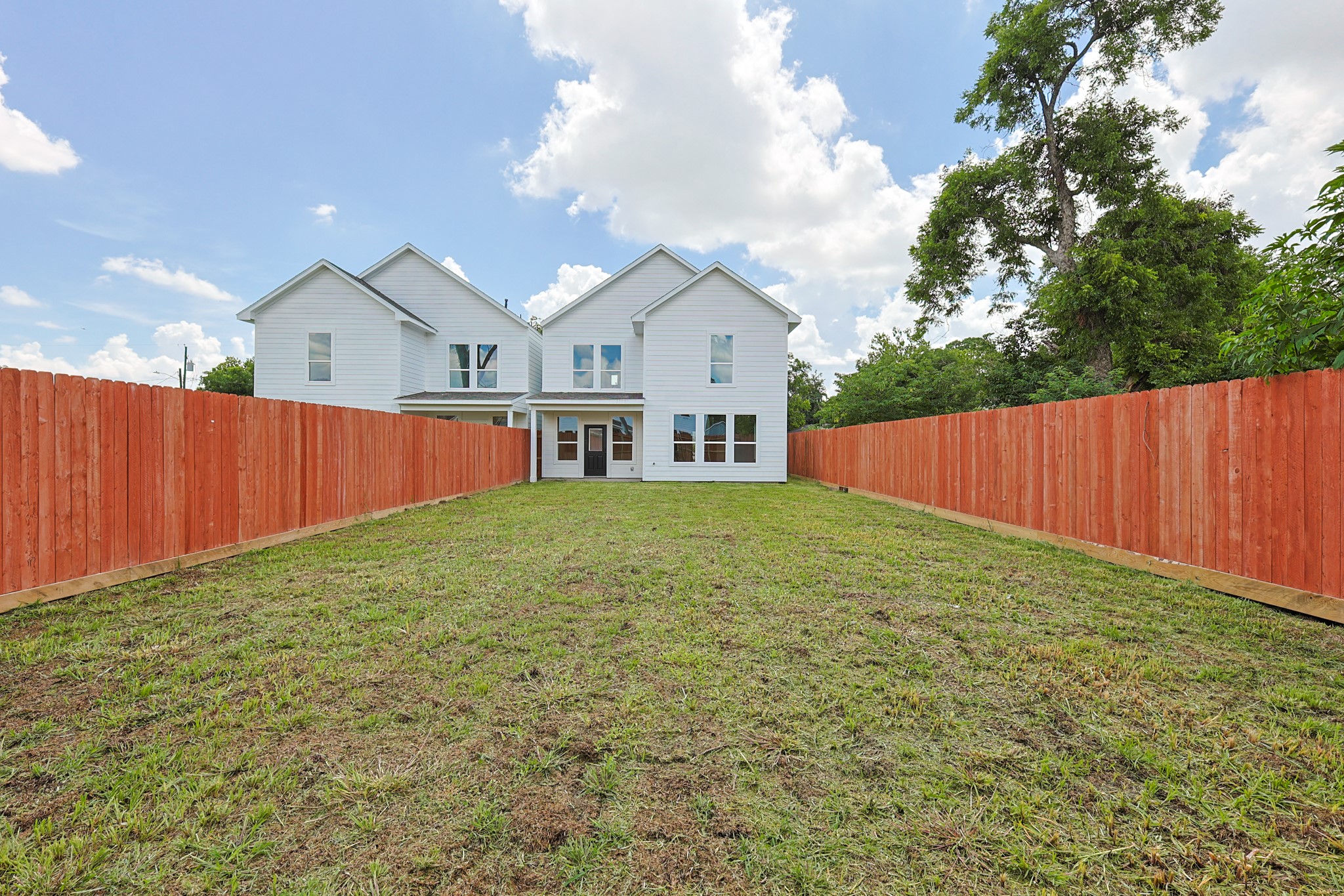 7413 Charlie Street Houston, TX 77088 - Photo 25 of 26 a view of a white house in front of a yard with wooden fence