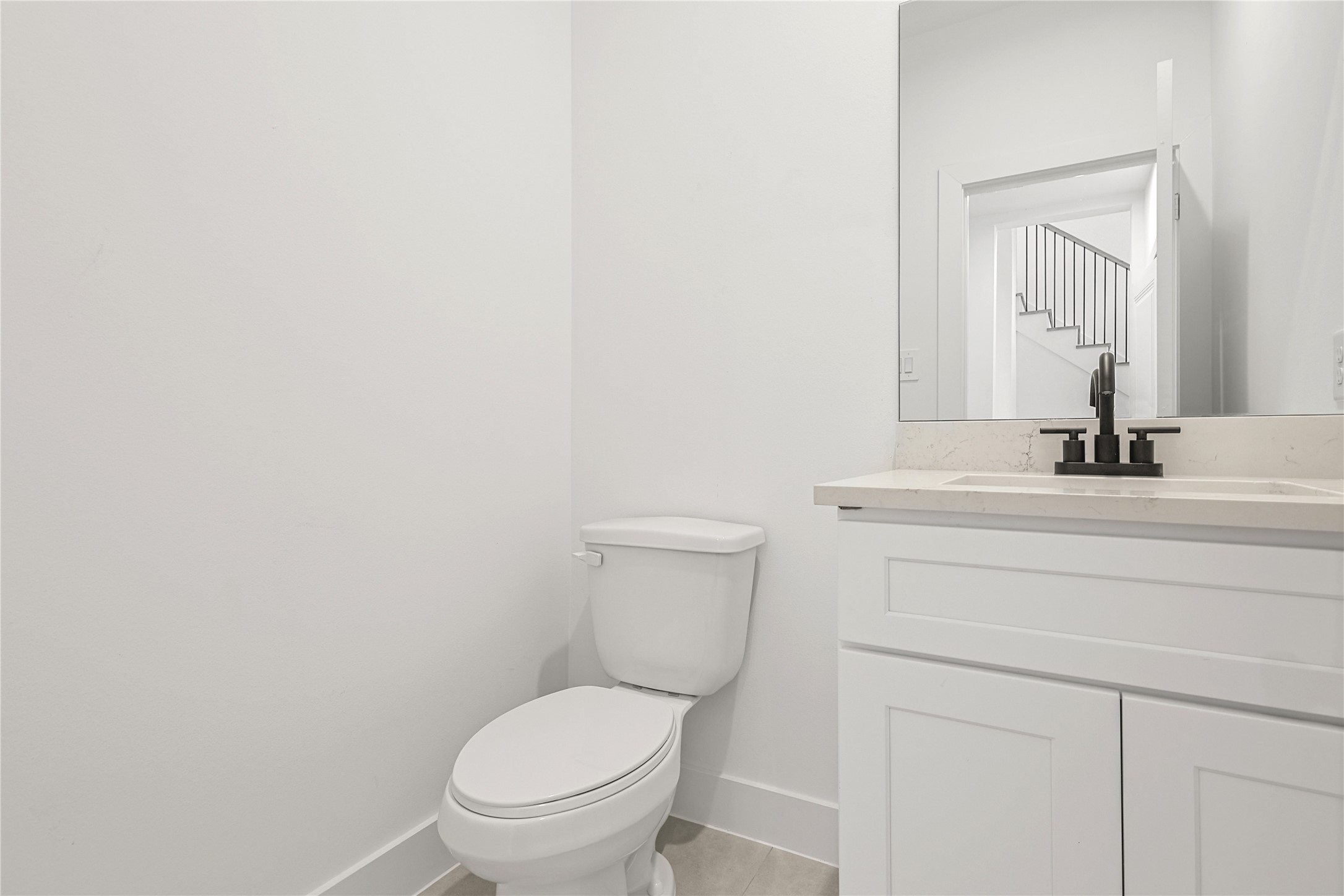 7413 Charlie Street Houston, TX 77088 - Photo 9 of 26 a bathroom with a toilet a sink and mirror