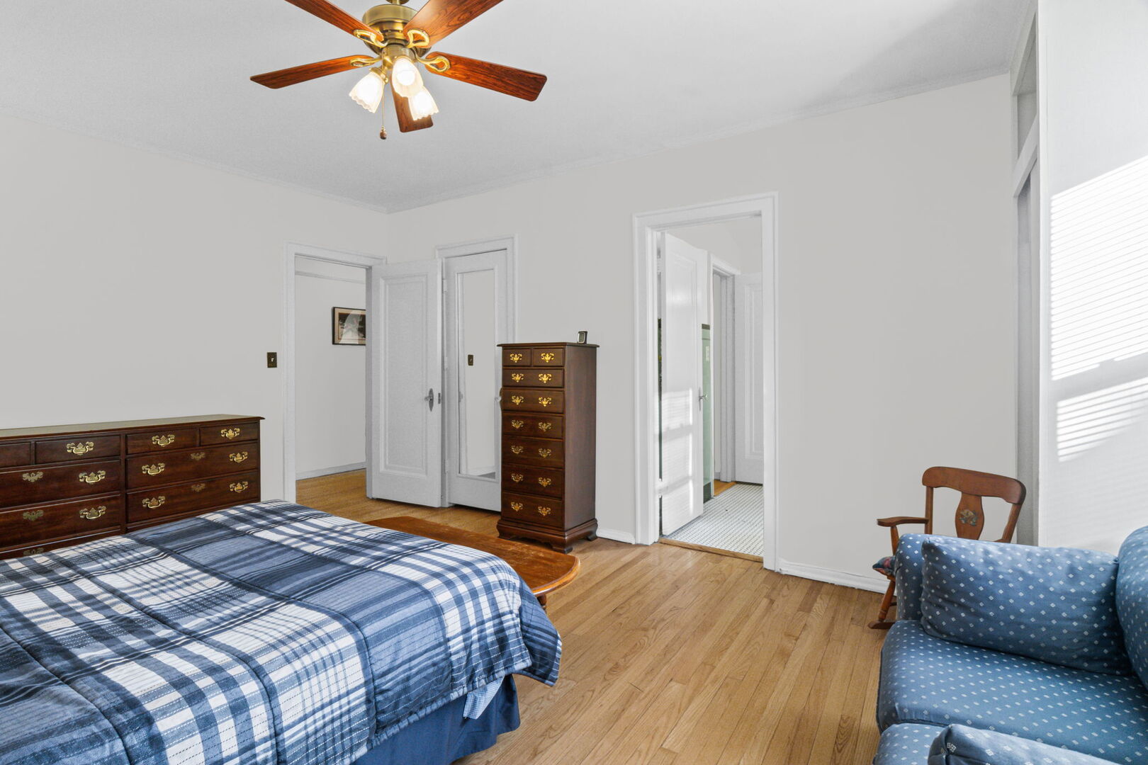 8037 Kenton Avenue, Unit 2S Skokie, IL 60076 - Photo 12 of 20 a bedroom with a bed and a chandelier