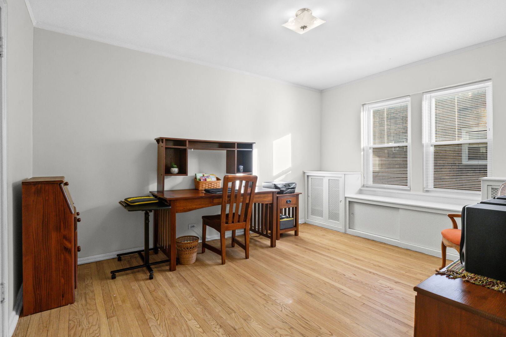 8037 Kenton Avenue, Unit 2S Skokie, IL 60076 - Photo 13 of 20 a view of a workspace with furniture and a window