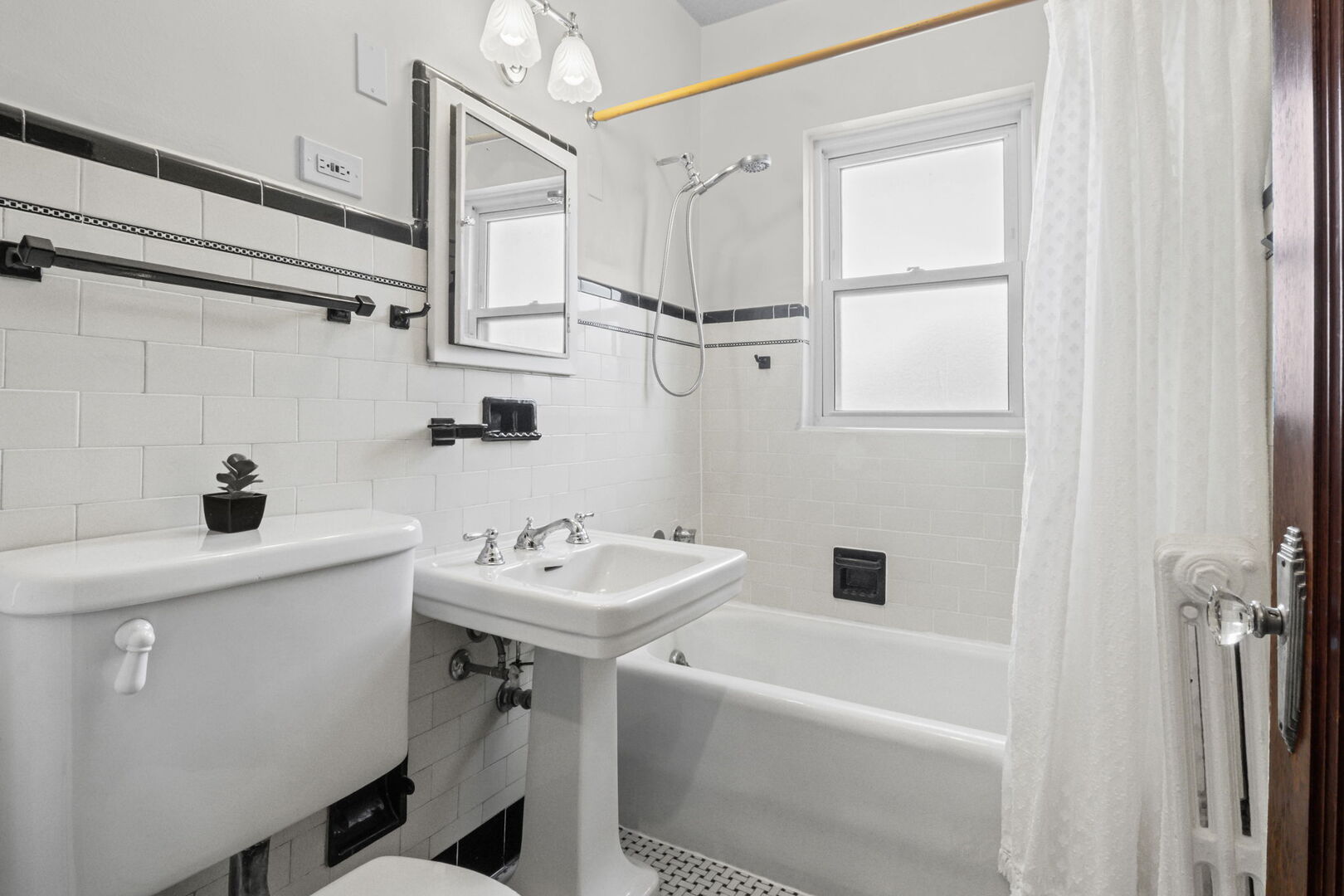 8037 Kenton Avenue, Unit 2S Skokie, IL 60076 - Photo 18 of 20 a bathroom with a sink a toilet and shower