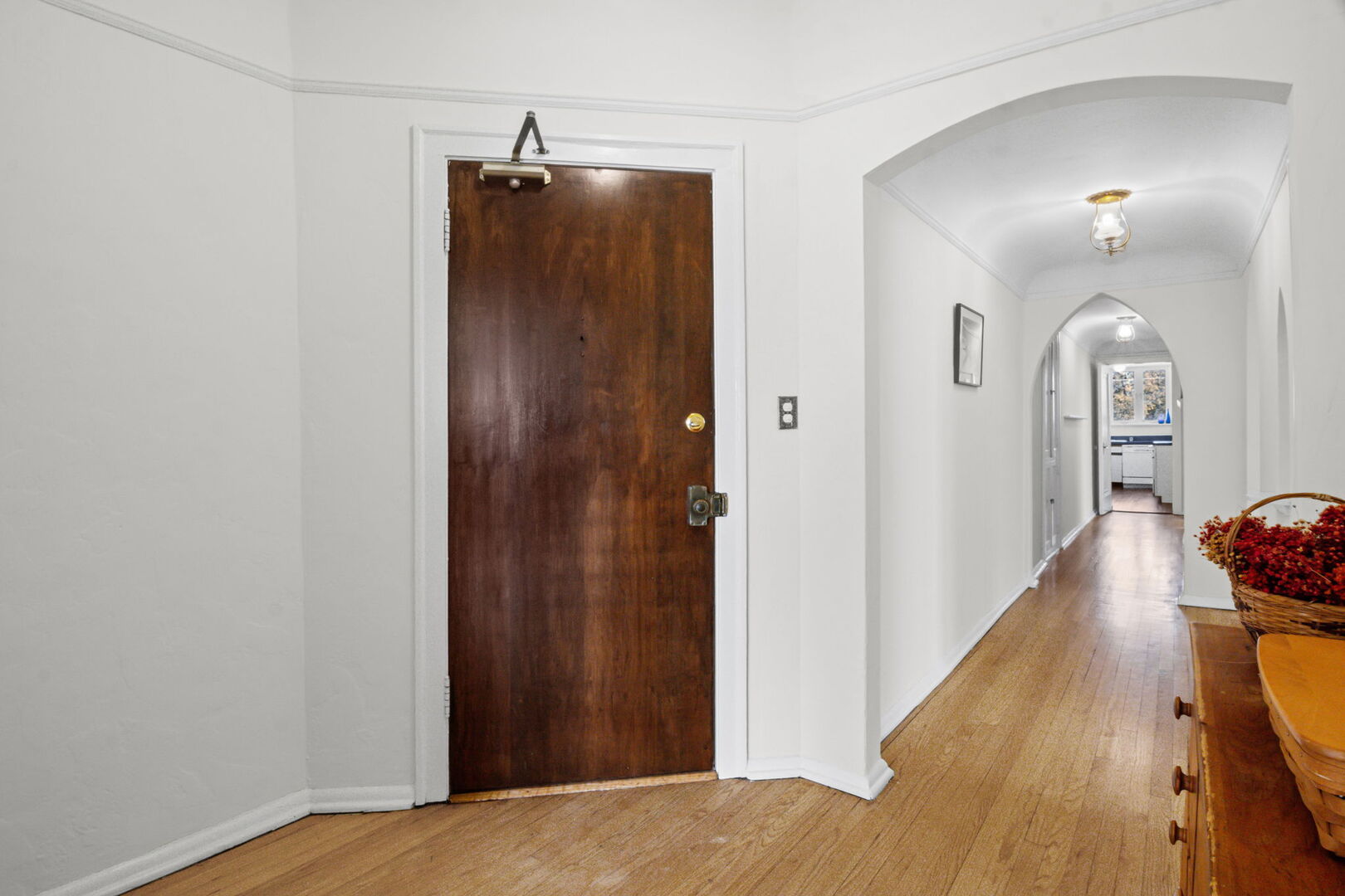 8037 Kenton Avenue, Unit 2S Skokie, IL 60076 - Photo 3 of 20 a view of a hallway with wooden floor and staircase