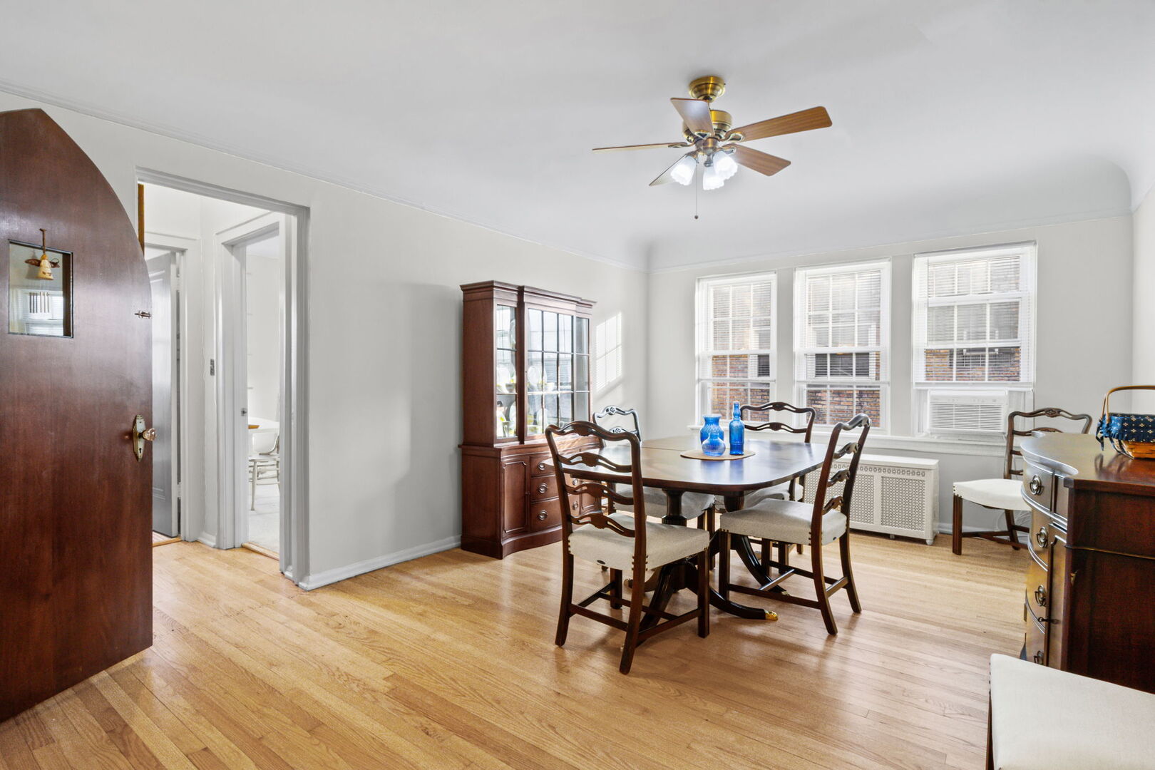 8037 Kenton Avenue, Unit 2S Skokie, IL 60076 - Photo 8 of 20 a view of a dining room with furniture window and wooden floor