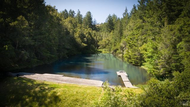 a view of a lake with a house in the background