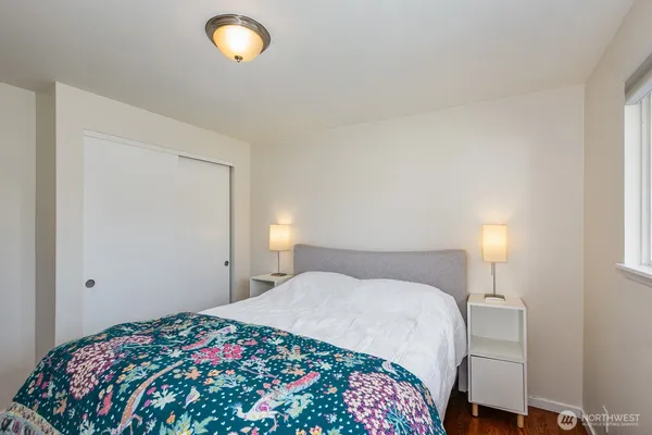 a bedroom with a bed and a lamp