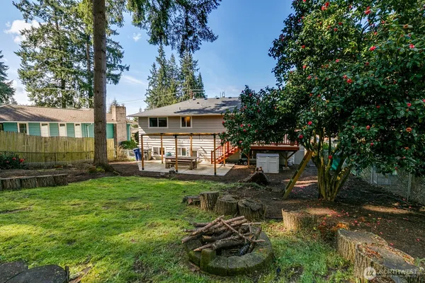 a view of a house with backyard sitting area and garden