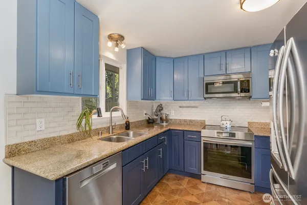 a kitchen with a sink stove and microwave
