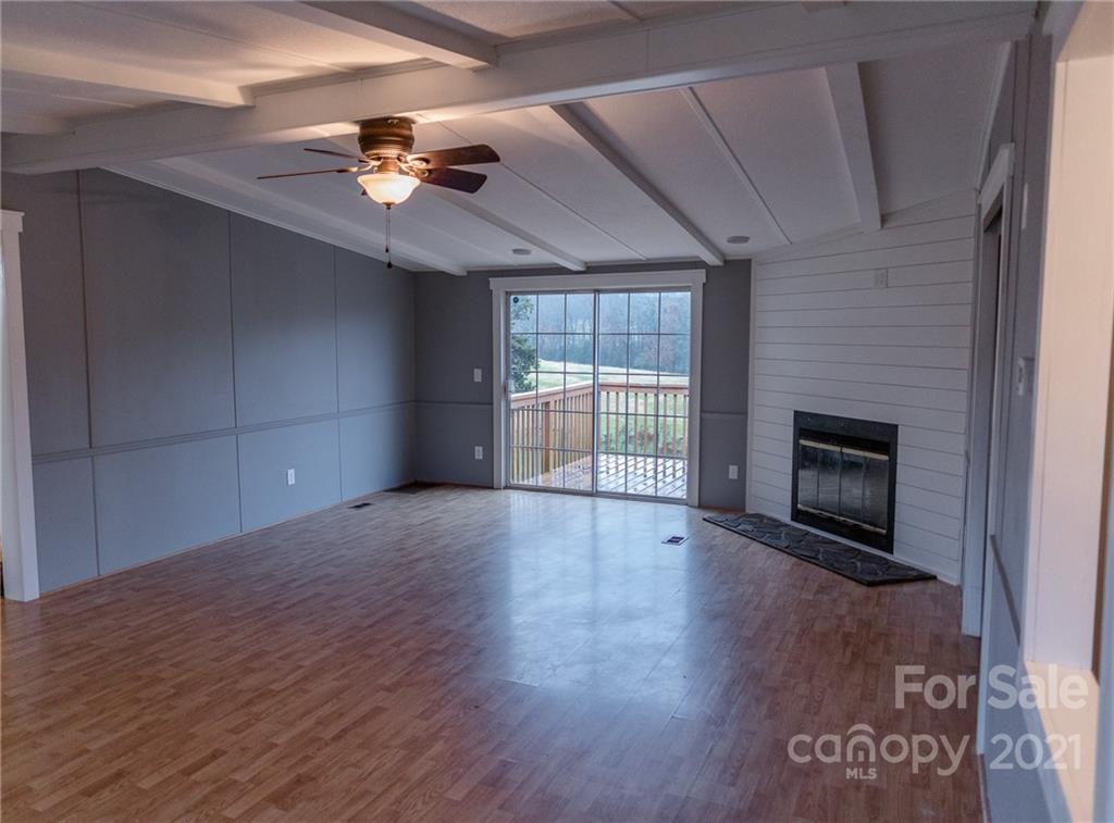 5432 Rushing Road Stanfield, NC 28163 - Photo 15 of 34 a view of an empty room with a fireplace and a window